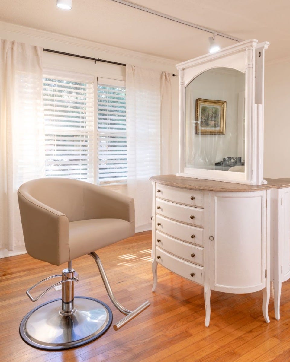 white antique vanity salon station and beige salon chair