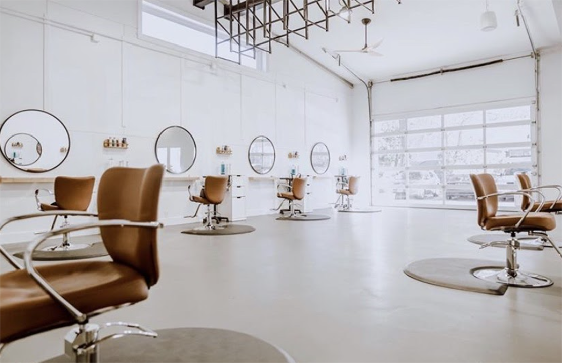 modern salon using styling stations and shelves to keep supplies organized