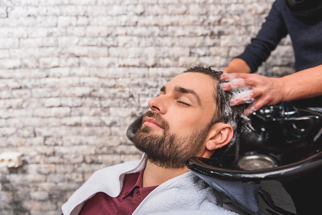 young man enjoying hairwash