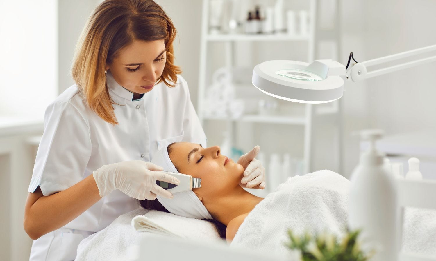 esthetician performing facial services on spa client