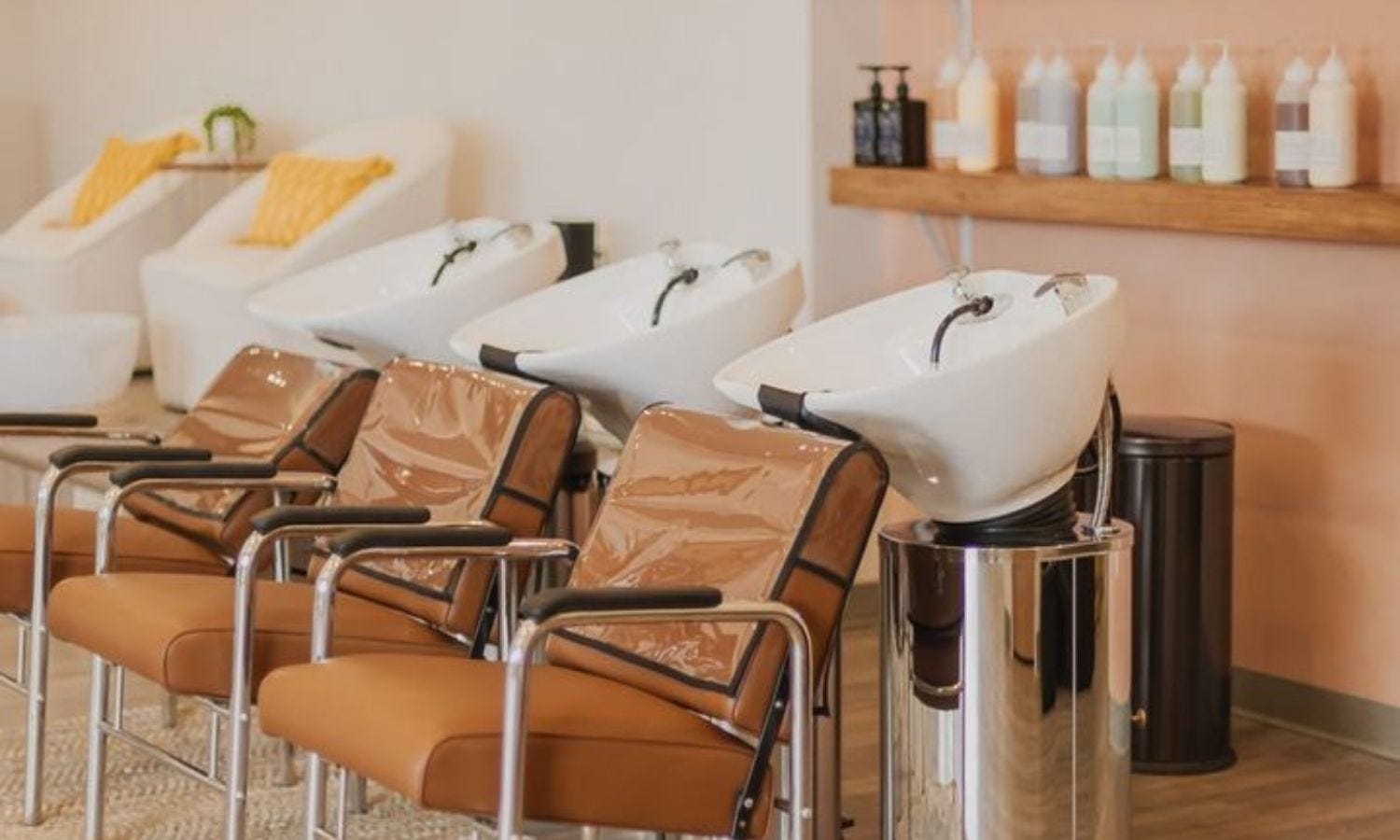 three shampoo chairs in a salon