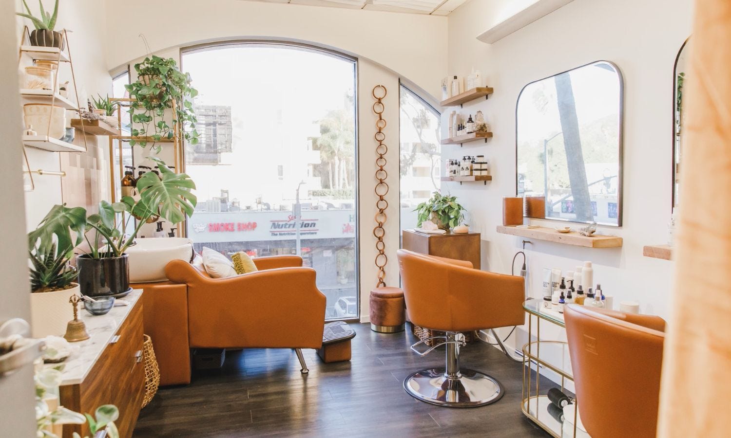 salon suite on the second floor of a building with salon suite equipment and a view of a commercial street outside the window