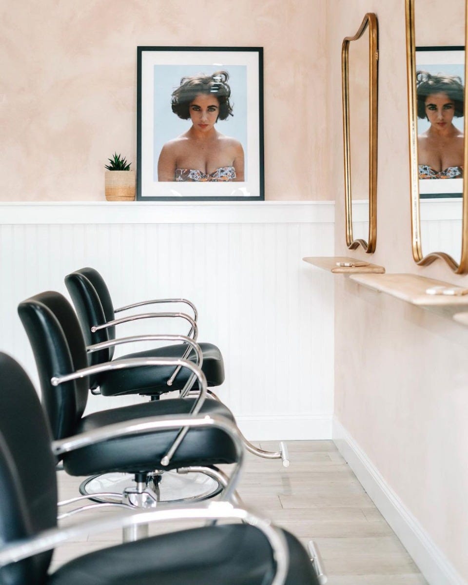 salon chairs with black vinyl seat and open armrests