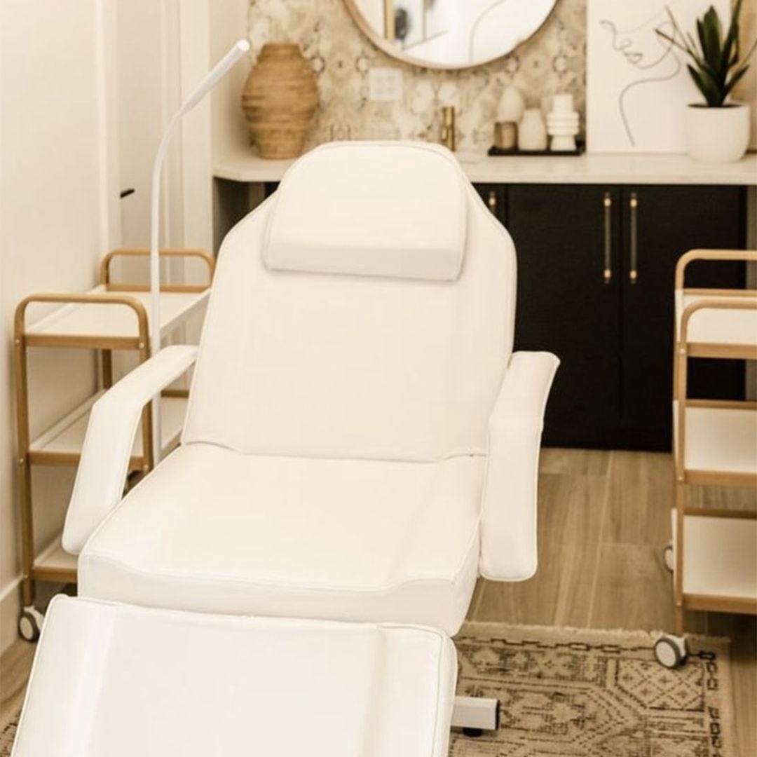 small modern esthetician room with neutral color palette, gold accents and elegant decor