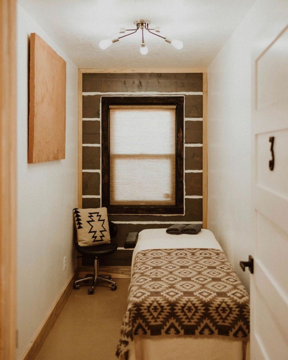 treatment room in waxing salon with table and wheeled technician chair