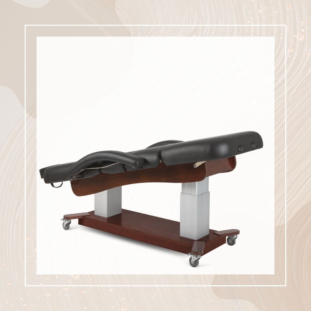 electric facial bed in black with wheeled base and versatile adjustability