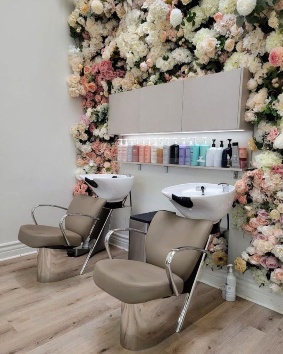 low budget fake flowers used to create accent wall for interior design in hair salon