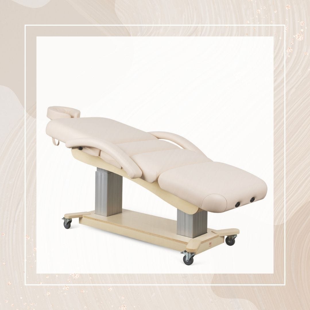 electric facial bed in beige with wheeled base and versatile adjustability