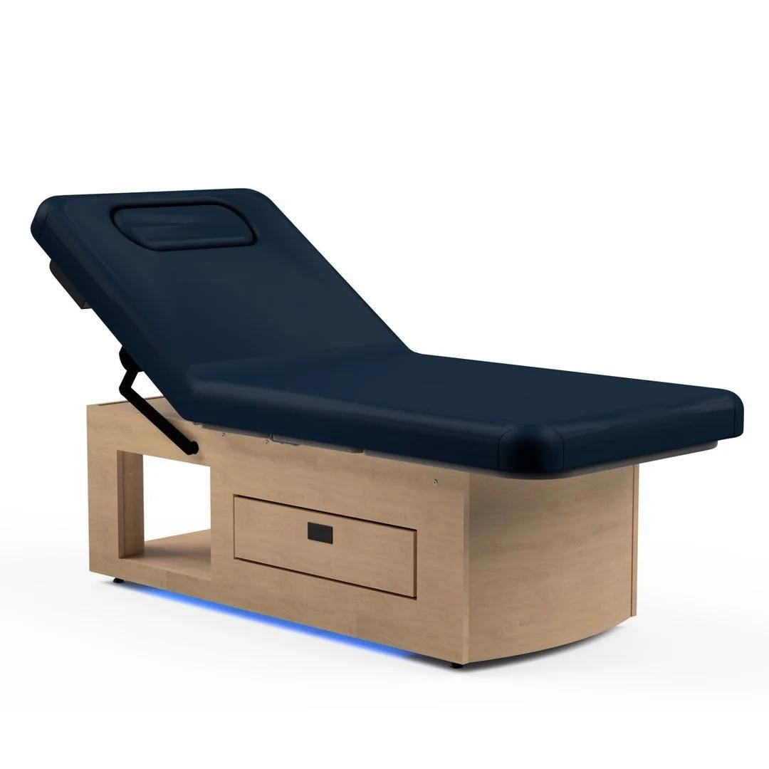 stationary massage table with display shelf in base, built-in warming drawer and adjustable electric top