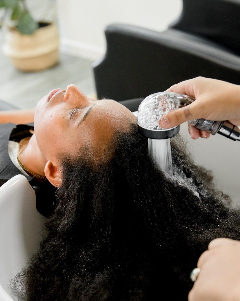 eco-conscious salon shampoo station with water-conserving sprayer