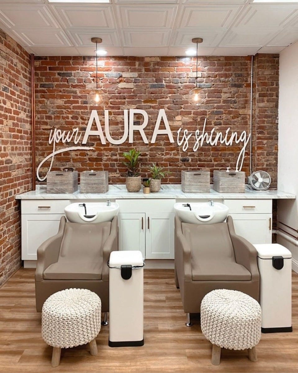 two comfortable shampoo systems with ottoman foot rests in a rustic salon