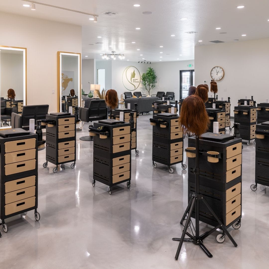 hair stylist training workshop with multiple salon trolleys, mannequin heads, styling chairs and mirrors