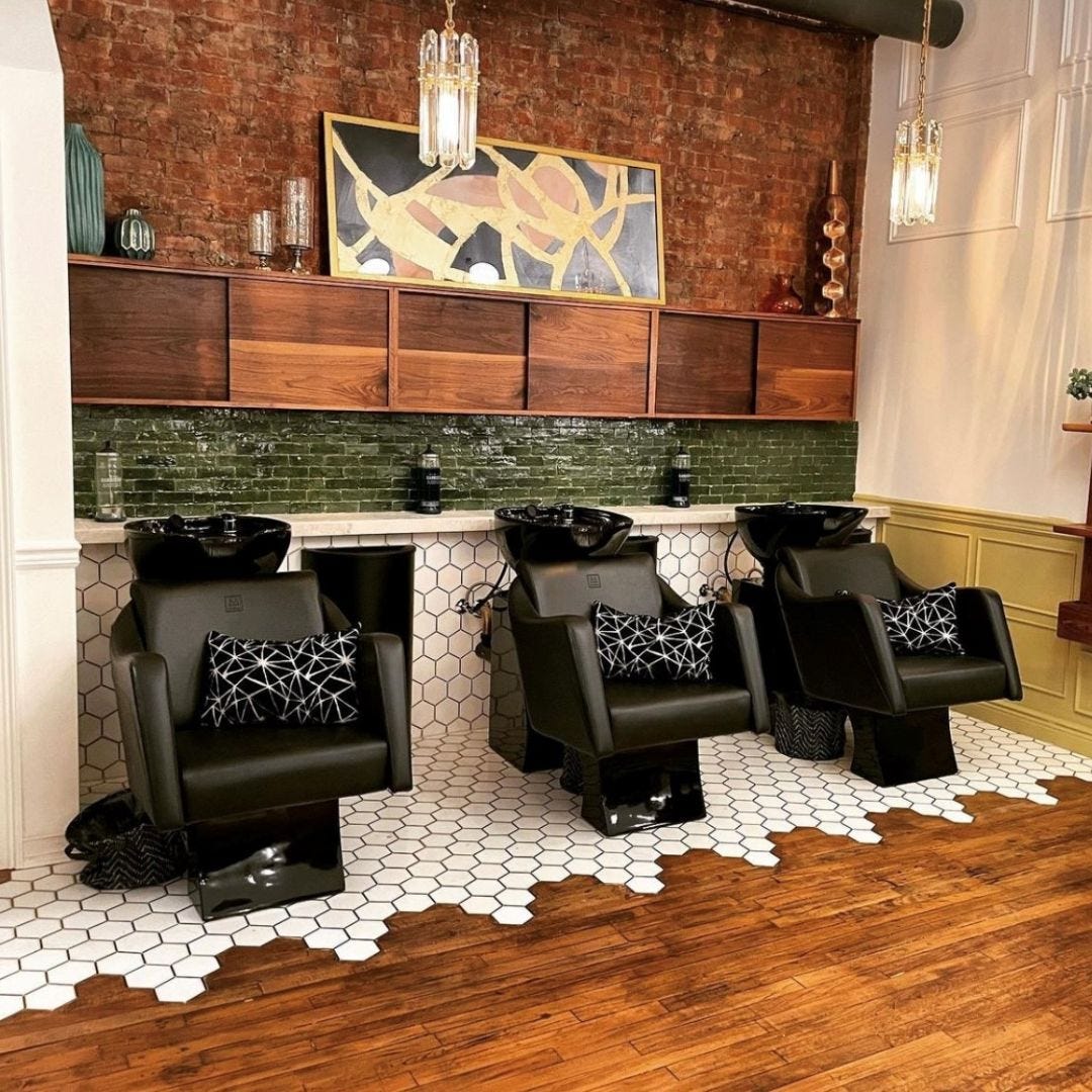 three black shampoo side wash units in a glamourous beauty salon