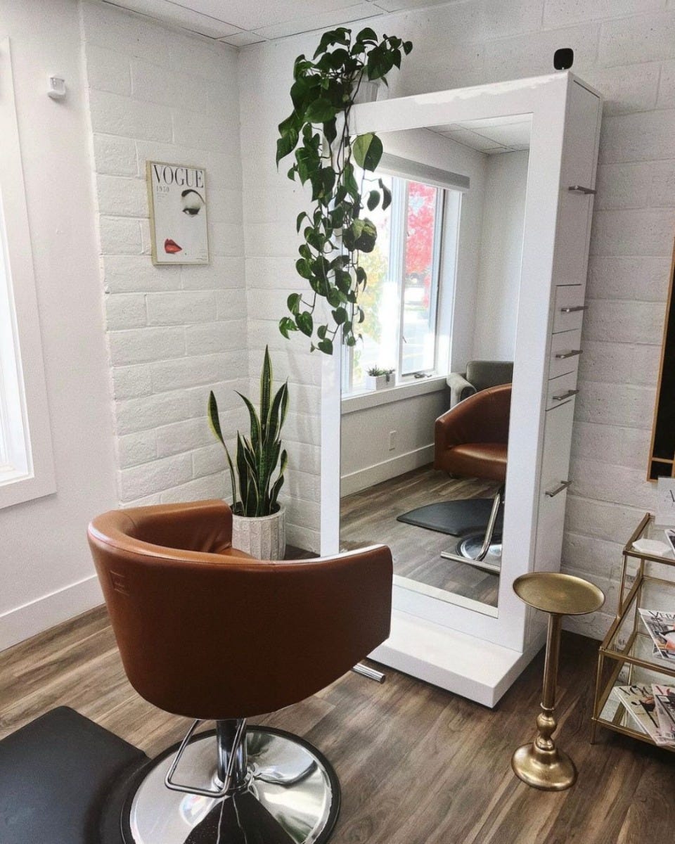 white tower-style salon station with mirror and multiple built-in drawers, cabinets and pull-out work surfaces