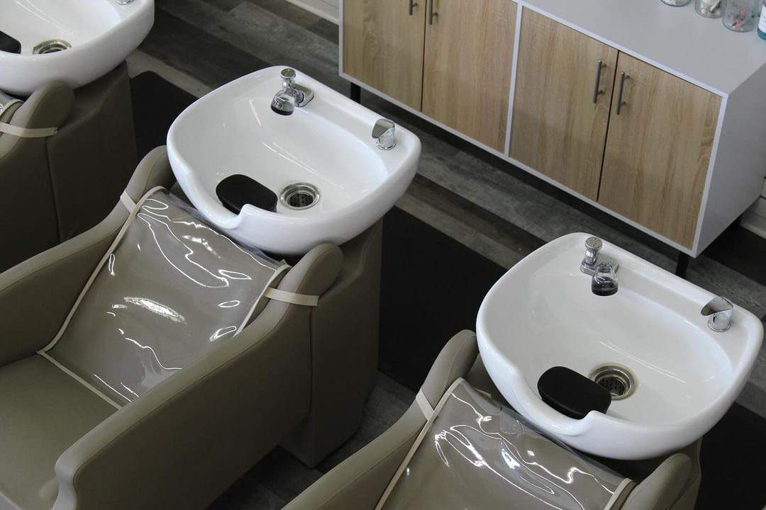 overhead view of two salon backwash units with stationary bowls and chair protectors