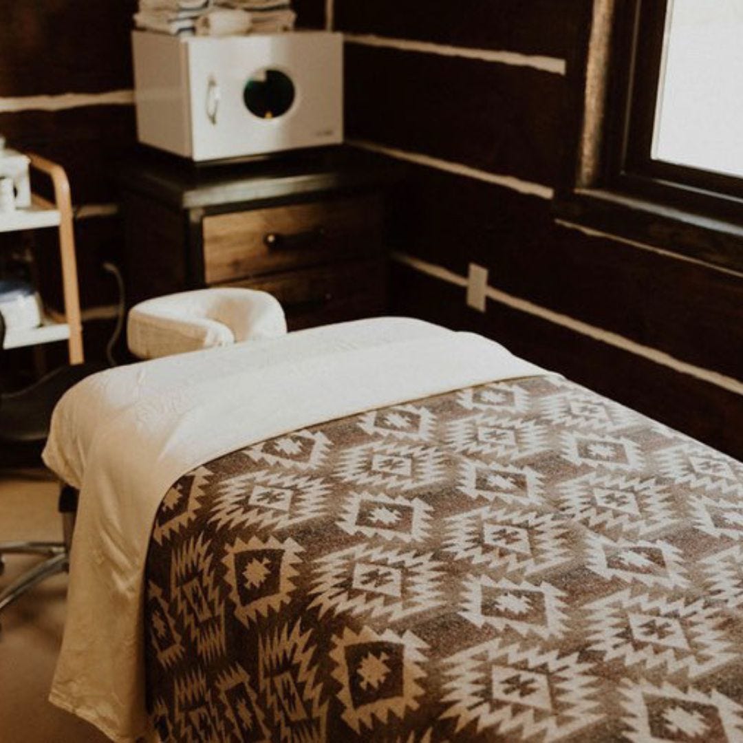 rustic esthetician room with reclaimed wood furniture, natural light and southwest decor