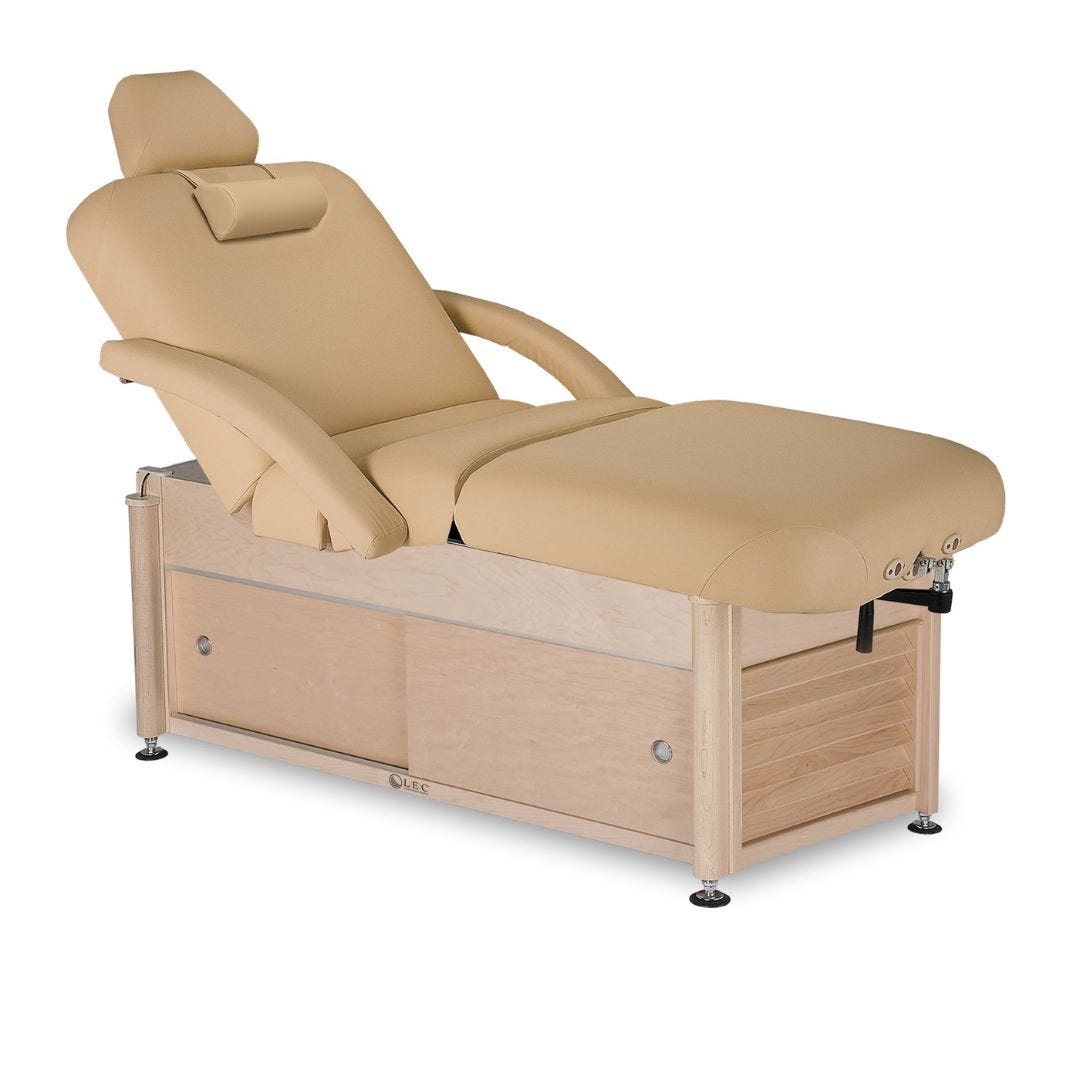 adjustable manual lift massage treatment table with cabinet storage in wood frame and articulated tilting top with removable arm rests and head rest