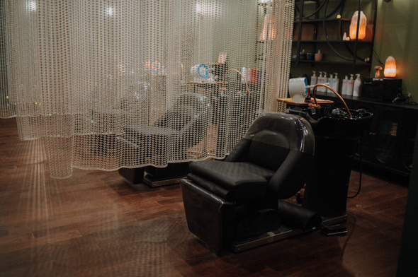 luxury hair salon shampoo area with beaded curtains separating shampoo stations and himalayan salt lamps