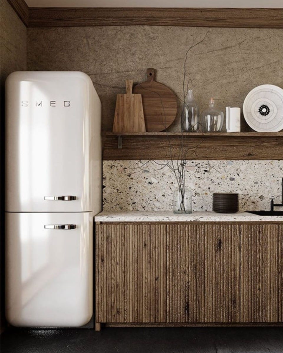 kitchen interior with retro-style SMEG refrigerator, quartz countertop and backsplash and fluted walnut cabinets