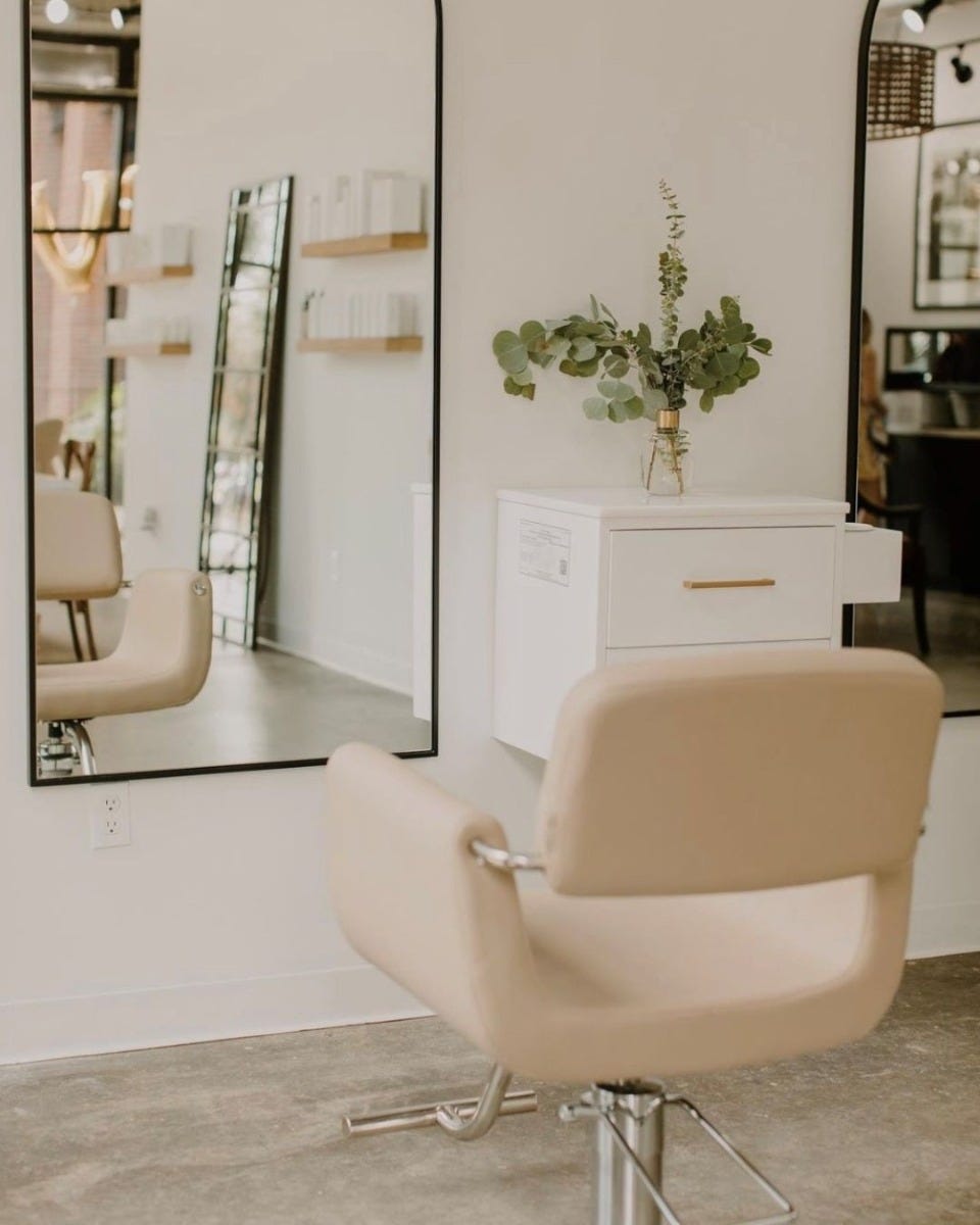 white wall-mounted styling station with quartz countertop, 2 drawers and appliance holders