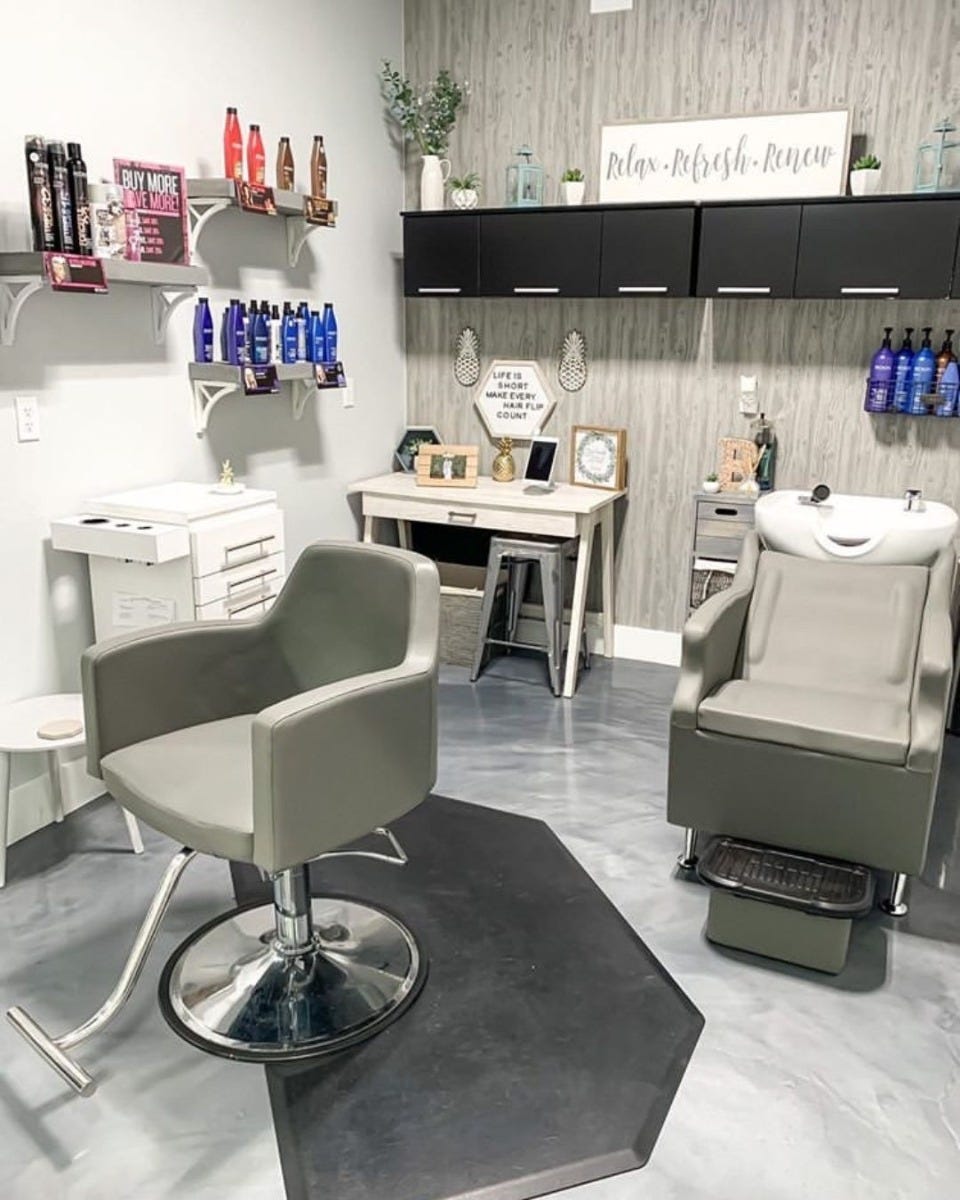 small salon suite space with shampoo bowl, styling chair and retail displays