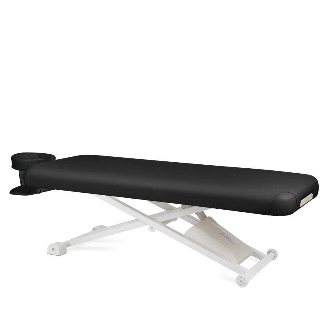 metal frame electric height adjustable massage table with flat top covered in black vinyl upholstery