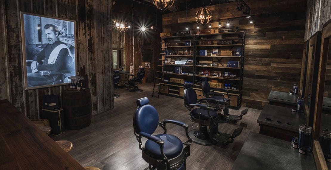 barber shop with essential supplies including disinfectant, hair and beard products and mirrors