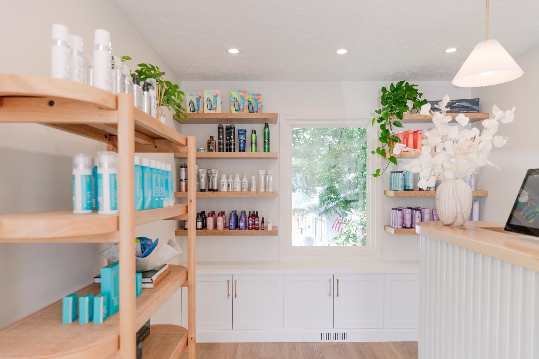 J. Italia Salon retail shelving with hair care products on display in reception area