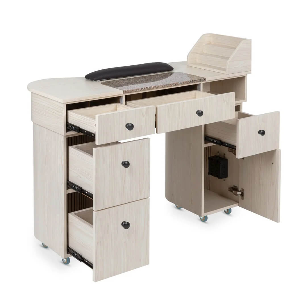 wheeled granite top nail desk in light grain wood with drawers and cabinets open to show storage capacity