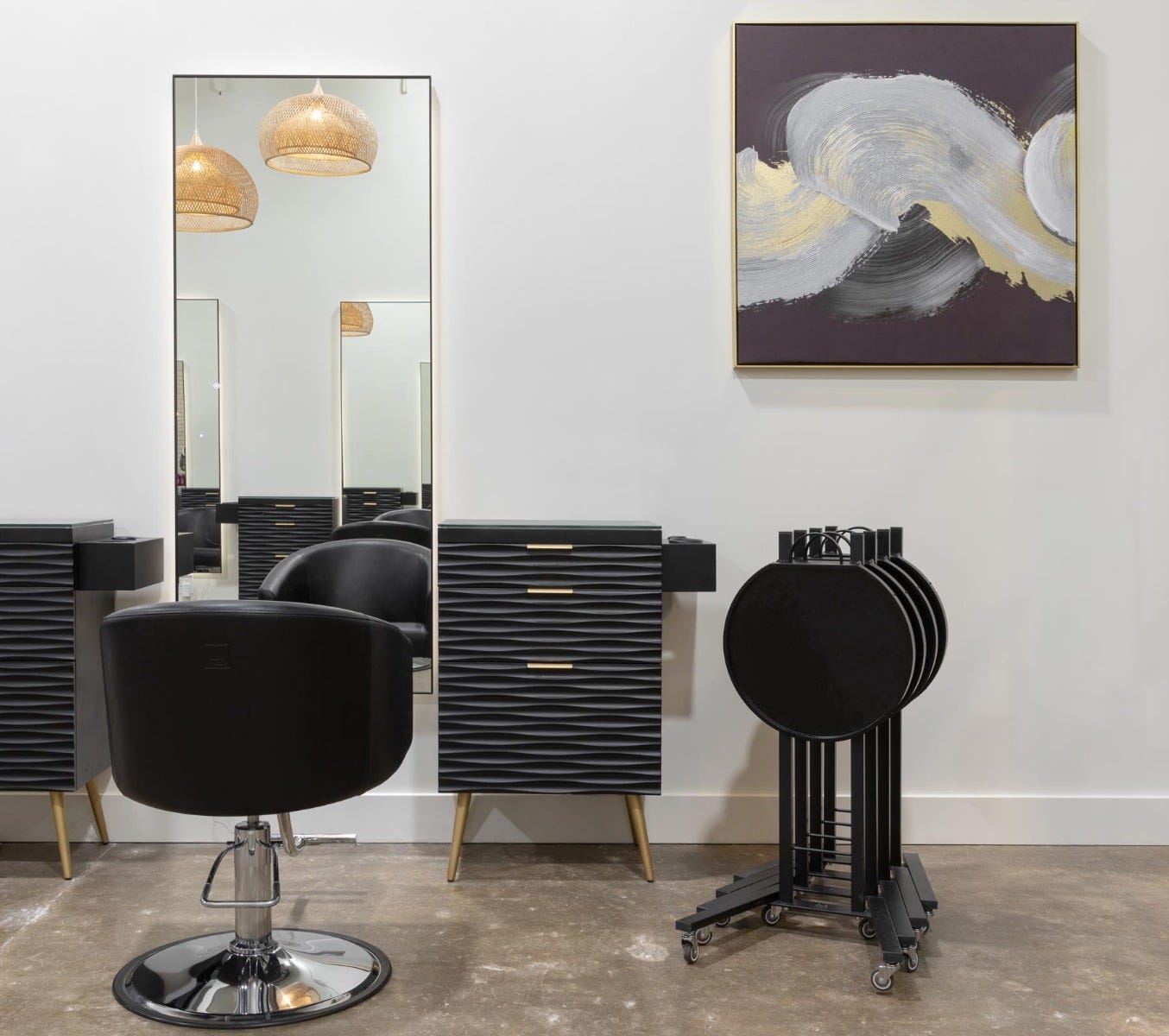 Radiant Hair Salon & Boutique styling station with full-length mirror, styling chair, storage drawers and salon service trays with abstract art on wall