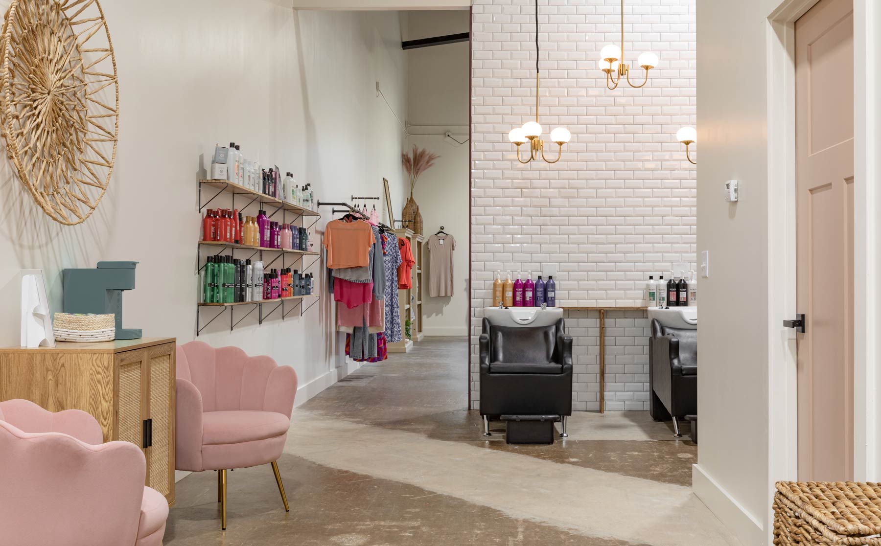 Radiant Hair Salon & Boutique view from salon area looking towards shampoo stations with retail shelving, waiting area and boutique visible