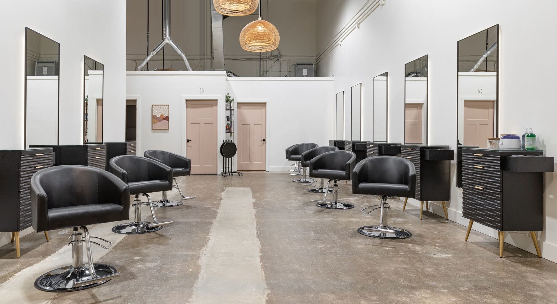 hair styling area of Radiant Salon & Boutique with eight styling stations and pendant lighting