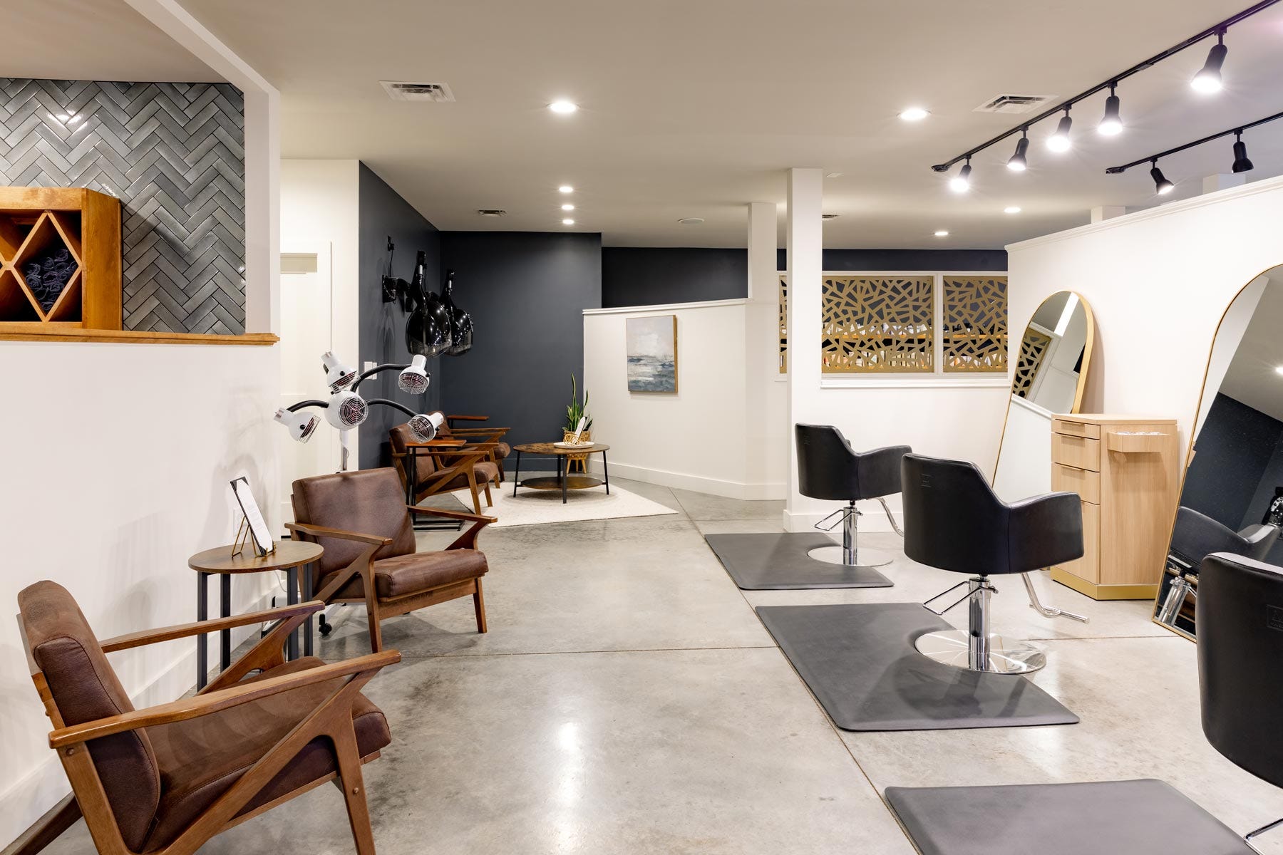 Vibe Salon interior view with styling chairs, hooded hair dryers and a hair color processor