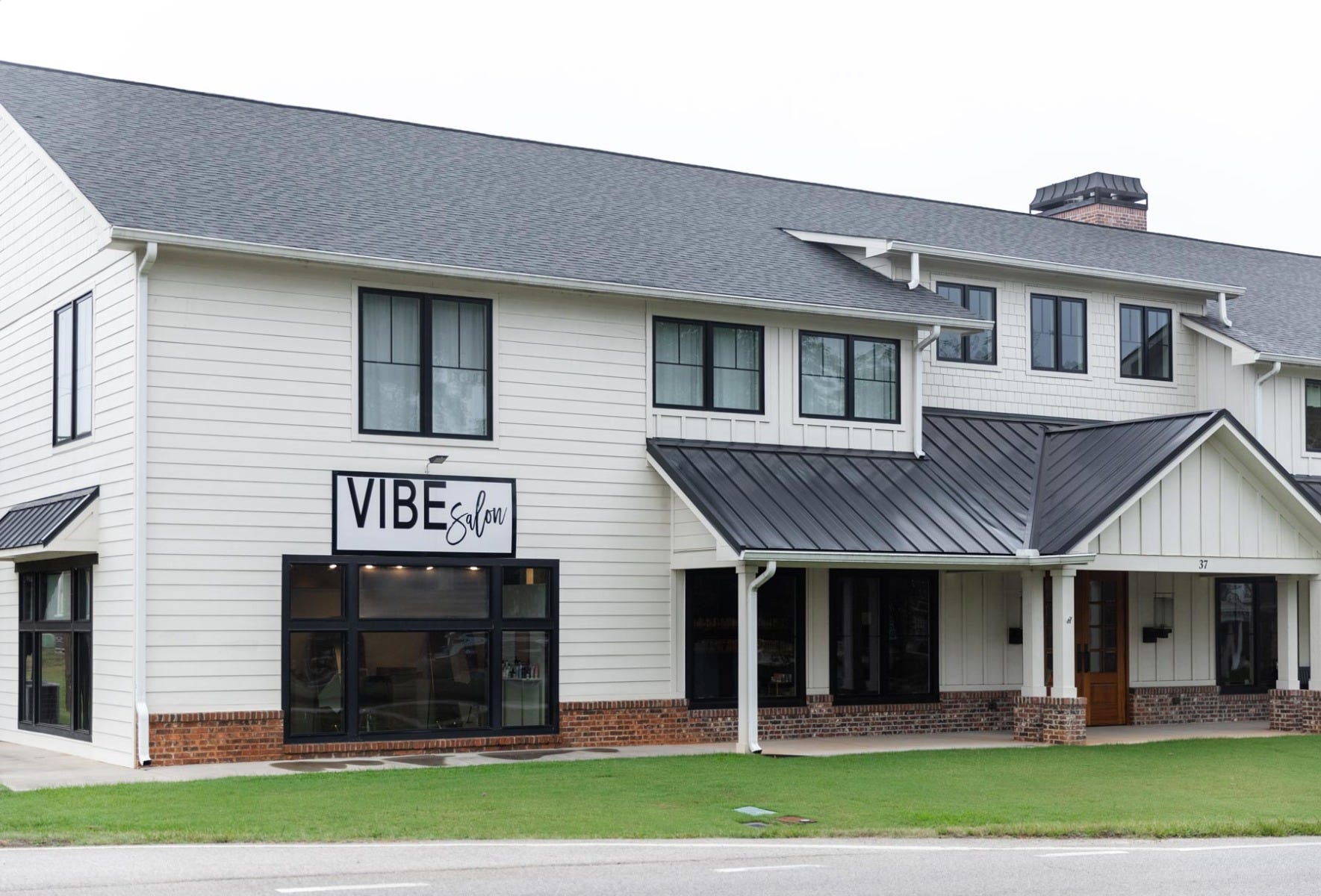 exterior view of Vibe Salon with signage above large front window