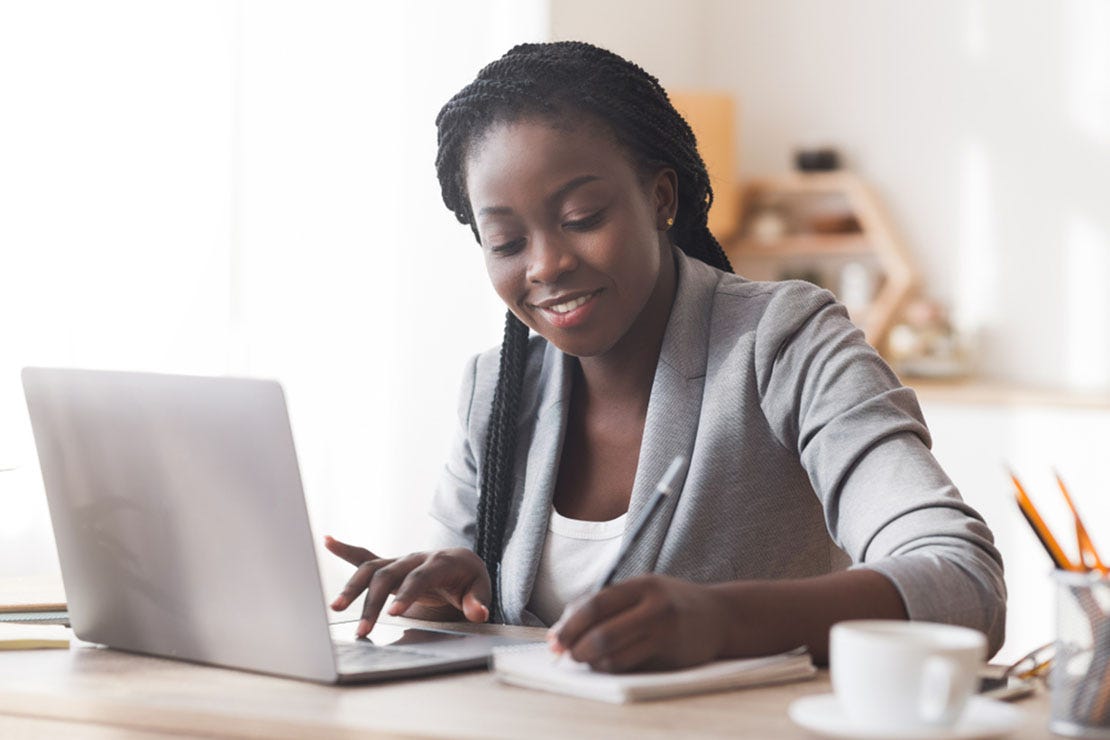 salon owner writing a press release on a laptop