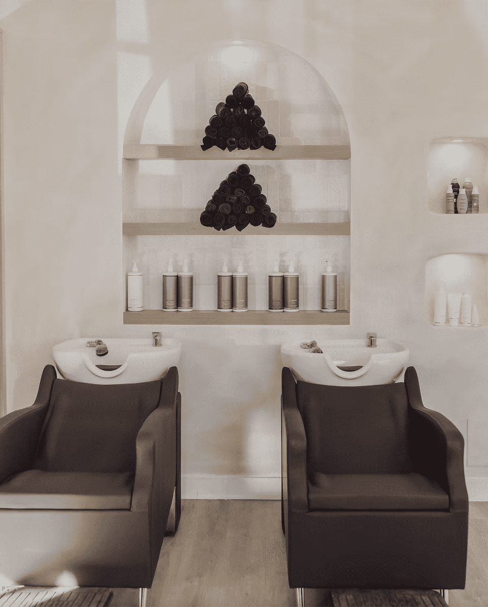 dark brown shampoo bowl and chair setups in a trendy hair salon