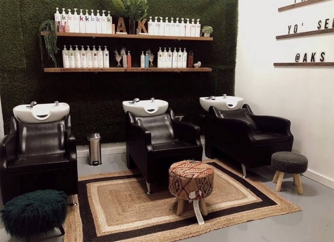 sustainable hair salon with eco-friendly interior design and eco-conscious hair products on display in shampoo area